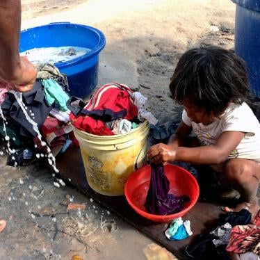 A girl from the Venezuelan Warao indigenous community plays at a shelter in Boa Vista. Water from showering and washing clothes ran off unpiped. February 11, 2017. 