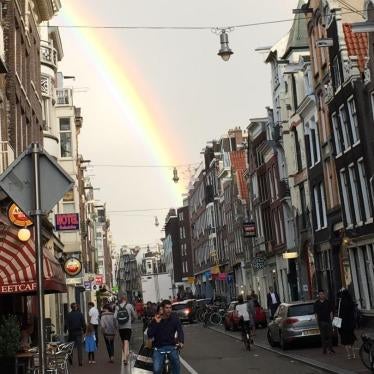 A rainbow over a typical Dutch shopping street in Amsterdam. 