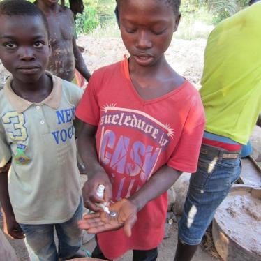 A 12-year-old boy shows the mercury he carries in his trousers’ pockets for gold processing in Homase, Amansie Central district, Ashanti Region, Ghana.