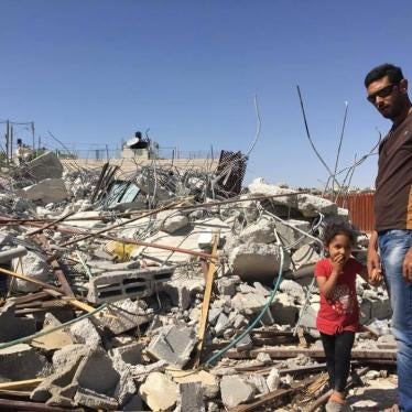 Ashraf Fawaqa and his daughter Sima, 4, stand next to the rubble of their East Jerusalem home on May 15; Israeli authorities demolished the house on May 4 because they lacked a permit.
