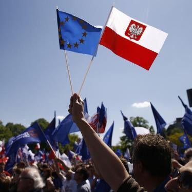 People wave EU and Polish flags as they march during anti-government demonstration organized by main opposition parties in Warsaw, Poland May 7, 2016.