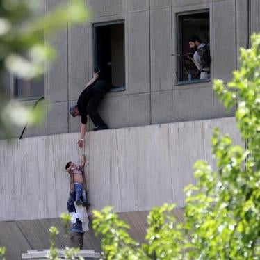 A boy is evacuated during an attack on the Iranian parliament in central Tehran, Iran, June 7, 2017. 