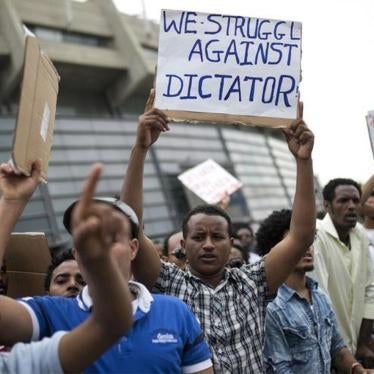 Eritrean refugees hold placards during a protest against the Eritrean government outside their embassy in Tel Aviv, Israel May 11, 2015.