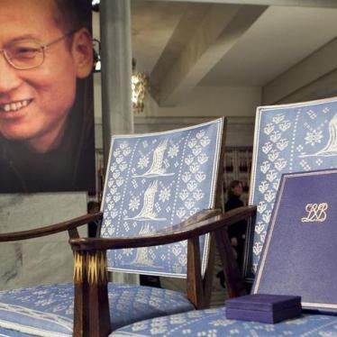 The Nobel certificate and medal is seen on the empty chair where this year's Nobel Peace Prize winner jailed Chinese dissident Liu Xiaobo would have sat, as a portrait of Liu is seen in the background, during the ceremony at Oslo City Hall December 10, 20