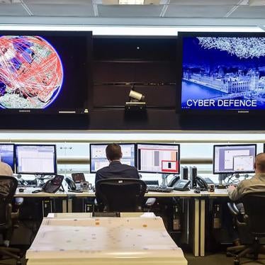 People sit at computers inside GCHQ, Britain's intelligence agency, in Cheltenham, UK, November 17, 2015.