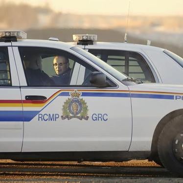 Two Royal Canadian Mounted Police (RCMP) officers talk at a blockade on a country road in the province of Alberta. © 2012 Reuters