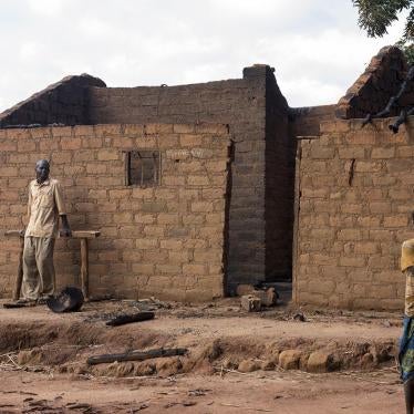 Residents of Marzé outside their burned home. Seleka and Peuhl fighters attacked the town in the Ouham province in July 2015.