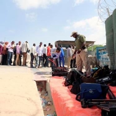 Journalists queue for a security sweep outside the venue of the presidential vote at the airport in Somalia's capital Mogadishu