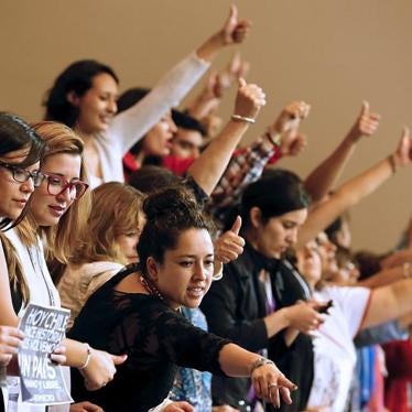Demonstrators raises their thumbs in approval inside Congress in favor of a draft law by the government which seeks to ease the country's strict abortion ban, in Valparaiso, Chile, March 17, 2016. The law passed the Senate on July 19, 2017.