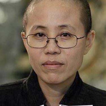   Liu Xia is shown holding photos of her deceased husband, Nobel Peace Prize winner Liu Xiaobo.
