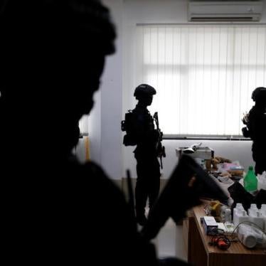 Counterterrorism police stand guard near evidence confiscated in raids on suspected militants at police headquarters in Jakarta, Indonesia, November 30, 2016.