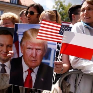 People holding portraits of U.S. President Donald Trump and Polish President Andrzej Duda wait for U.S. President Donald Trump's public speech at Krasinski Square, in Warsaw, Poland July 6, 2017. REUTERS/Kacper Pempel