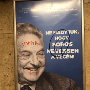 Anti-Soros campaign poster defaced with "vampire" scribbled across Soros' face. Budapest metro, July 12, 2017. 