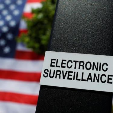 A notice of electronic surveillance is posted near a 95-by-50-foot American flag unfurled on the side of an apartment complex in Manchester, New Hampshire, U.S., June 14, 2017. 