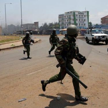 Policemen chase protesters in Kisumu, Kenya August 11, 2017.