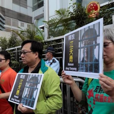 Pro-democracy demonstrators hold up portraits of Chinese disbarred lawyer Jiang Tianyong, demanding his release, during a demonstration outside the Chinese liaison office in Hong Kong, China December 23, 2016.