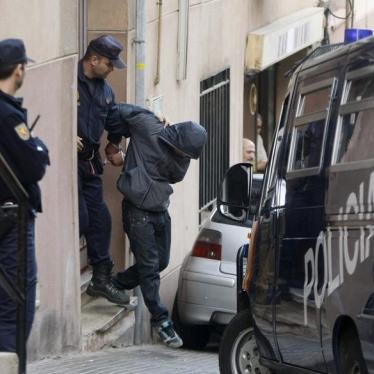 Police escort a suspect who was detained during early morning raids in an operation against a group suspected of financing and recruiting Islamist militants in Santa Coloma de Gramanet, near Barcelona, October 16, 2008.