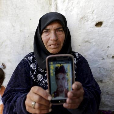 A mother shows a picture of her son, who was detained by authorities in the northern Syrian province of Idlib, Syria, March 20, 2016. She has not heard any news about her son since then. 