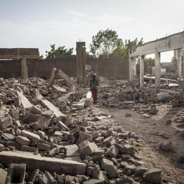A girl walks through the rubble of destroyed buildings in Banki, northeast Nigeria, April 2017.