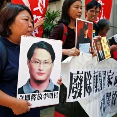 Pro-democracy protesters carry a photo of detained Taiwanese rights activist Lee Ming-Che (L) and other activists during a demonstration in Hong Kong, China September 11, 2017.