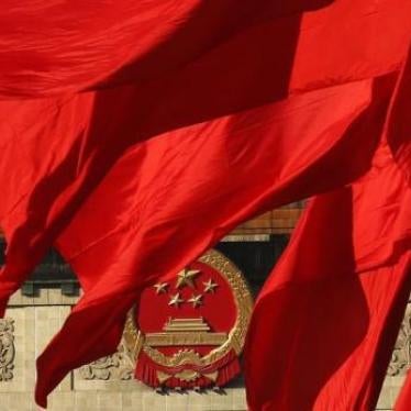 The Great Hall of the People, where the Chinese Communist Party plenum is being held, is seen behinds red flags in Tiananmen square, December 05, 2013.