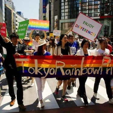Participants hold a banner as they march during the Tokyo Rainbow Pride parade in Tokyo April 26, 2015.