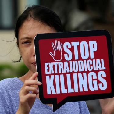A woman displays a placard during a protest against Philippine President Rodrigo Duterte’s “war on drugs” in front of a local court in Muntinlupa city, south of Manila, Philippines October 13, 2017.