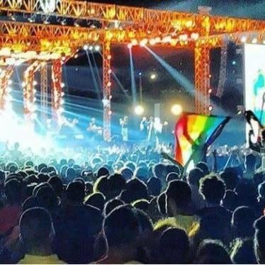 Young people wave a rainbow flag at a Cairo concert featuring the Lebanese Band Mashrou’ Leila. Activist Ahmed Alaa confirmed that he raised a rainbow flag at the concert in a Buzzfeed video including this image prior to his arrest. 