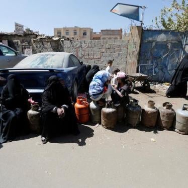 Women sit on cooking gas cylinders lined up outside a gas station amid supply shortage in Sanaa, Yemen November 7, 2017. 