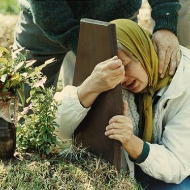 Photo 4A mother grieves over the grave of her 2nd son, and last child, who, along with his brother, were killed during the siege of Sarajevo.