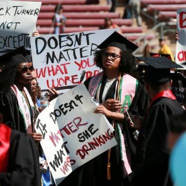 Protesters hold signs to raise awareness of sexual assault on campus at the Stanford University commencement ceremony in Palo Alto, California on U.S. June 12, 2016. 