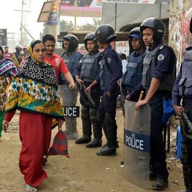 Bangladesh police stand guard in front of garment factories in Ashulia on December 26, 2016, when factories re-opened after a five-day shut down in response to garment workers’ wage strikes. 
