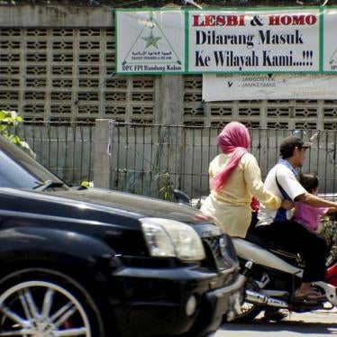 Motorcyclists ride past a banner calling for LGBT people to leave the Cigondewah Kaler area in Bandung, Indonesia, January 27, 2016.
