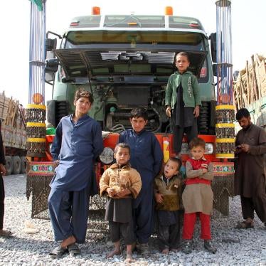 An Afghan refugee family forced out of Pakistan stands by a hired truck laden with their possessions after an overnight journey, October 2016