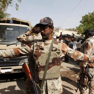 A Pakistan Ranger gestures to stop members of the media from taking pictures at an anti-terrorism court in Karachi, Pakistan on March 12, 2015.