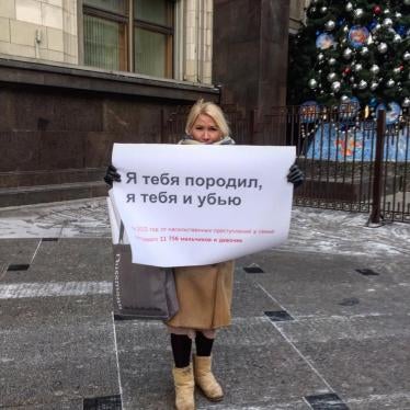 Russian activist protesting decriminalization of domestic violence in front of Russia’s state parliament building.