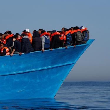 Migrants on a wooden boat await rescue by the Malta-based NGO Migrant Offshore Aid Station in the central Mediterranean in international waters off the coast of Sabbath, Libya on April 15, 2017. © 2017 Reuters