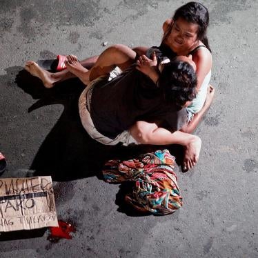 Jennelyn Olaires, 26, cradles the body of her partner, who was killed by a vigilante group, according to police, in a spate of drug-related killings in Pasay City in Metro Manila, July 23, 2016.