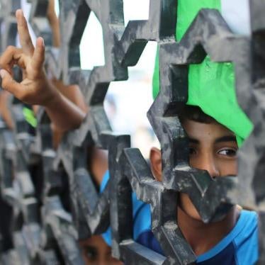 A Palestinian boy takes part in a protest regarding four missing Palestinian men believed to be in Egyptian custody, at the gate of Rafah crossing between Egypt and the Gaza Strip, August 20, 2015. 