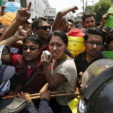Nepalese police try to stop protesters marching towards the prime minister's office and other ministries, during a demonstration against delays on reconstruction and relief during the first anniversary of the 2015 earthquakes in Kathmandu, April 24, 2016.