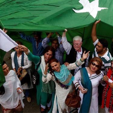 Supporters of the Gender Interactive Alliance dance and chant slogans as they pose with a national flag ahead of the Independence Day in Karachi, August 13, 2016.