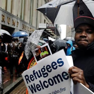 Demonstrators march outside the Trump Building at 40 Wall St. as part of a protest against the US government's refugee ban in New York on March 28, 2017. © 2017 Reuters