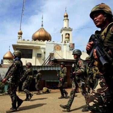 Government troops walk past a mosque before their assault with insurgents from the so-called Maute group, who have taken over large parts of Marawi City, southern Philippines on May 25, 2017