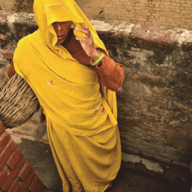 A Dalit woman removes excrement from dry toilets in Kasela village in Uttar Pradesh, India, where the state has failed to enforce laws prohibiting the practice of “manual scavenging.” 