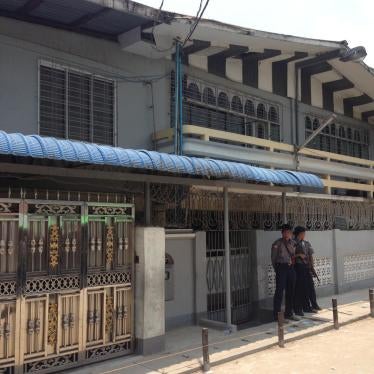 Two police officers guard one of the closed madrasas in Thaketa Township, Rangoon, after authorities inspected the building, April 29, 2017.
