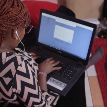 Photo from behind of female blogger Wanjeri Nderu typing on her computer