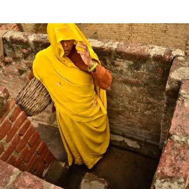 A Dalit woman removes excrement from dry toilets in Kasela village in Uttar Pradesh, India, where the state has failed to enforce laws prohibiting the practice of “manual scavenging.”