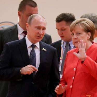 German Chancellor Angela Merkel talks to Russia's President Vladimir Putin at the start of the first working session of the G20 meeting in Hamburg, Germany, July 7, 2017