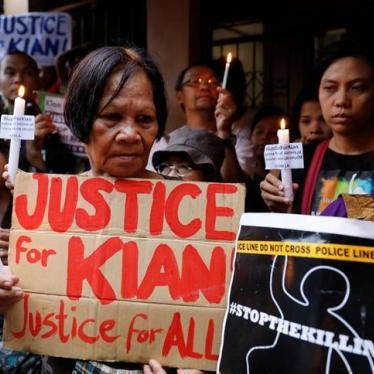 Protesters hold placards and lit candles at the wake of Kian delos Santos, a 17-year-old high school student, who was among the people shot dead last week in an escalation of President Rodrigo Duterte's war on drugs, in Caloocan City, Metro Manila, Philip