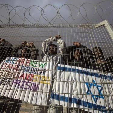 African migrants gesture behind a fence during a protest against Israel's detention policy towards them, at Holot, Israel's southern Negev desert detention centre February 17, 2014.